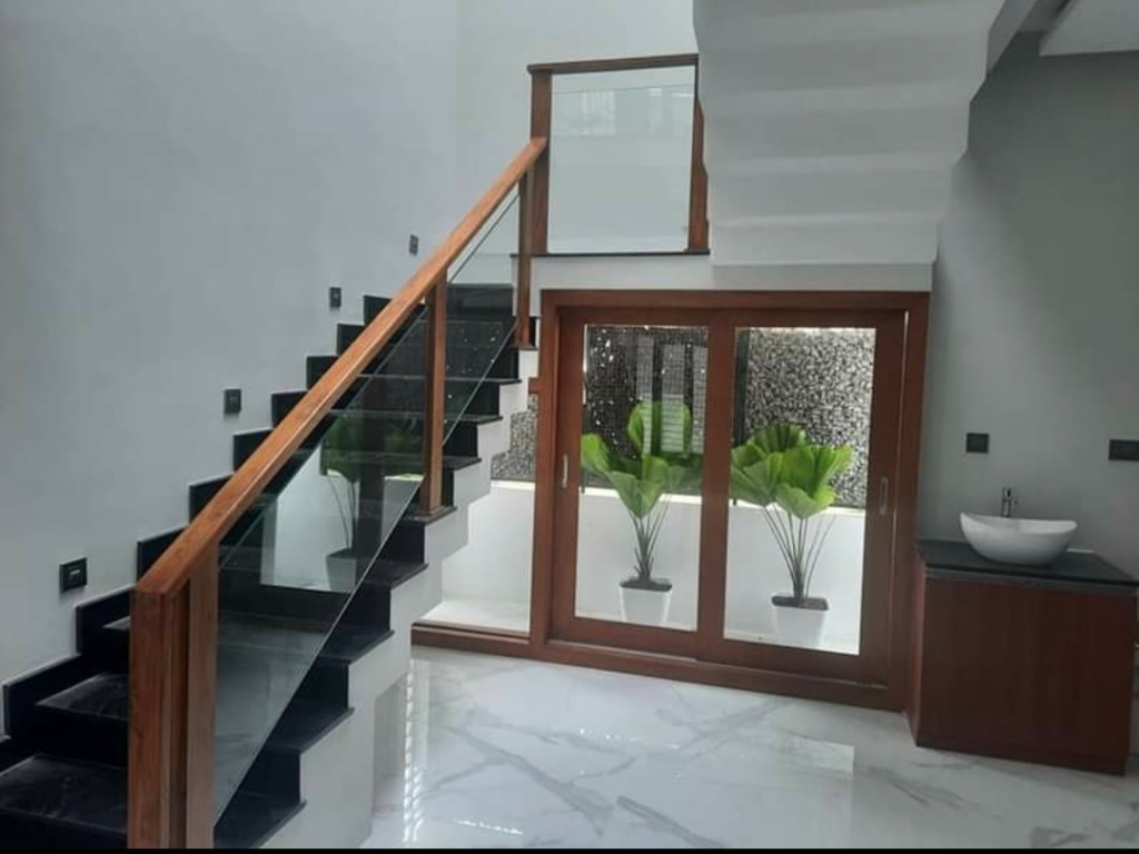 Loyal Projects completed modern wooden staircase with glass paneling